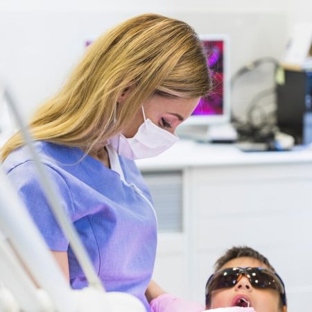 close-up-female-doctor-checking-boy-s-teeth_23-2147905942